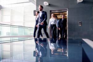 People walking out of building elevator